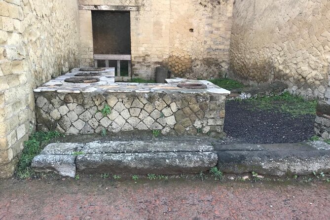 Herculaneum - Small Group Tour - The seafront visit: skeleton shelters and a preserved wooden boat