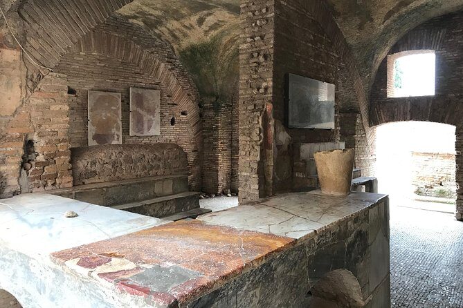 Private tour of Ostia, the ancient city harbor, by van with a PhD archaeologist - Meeting Fernando, the Archaeology Brain, and Your Earbuds Moment