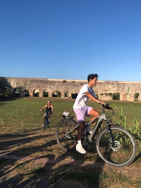 Rome: Tour by Top E-bike Ancient Appian Way Catacombs Aqueducts - The Route Out of the City: Past the Colosseum and Through Porta San Sebastiano
