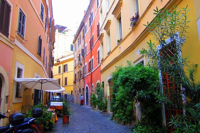 Trastevere and Rome's Jewish Ghetto Half-Day Walking Tour - Crossing toward Isola Tiberina: river views and a synagogue exterior moment